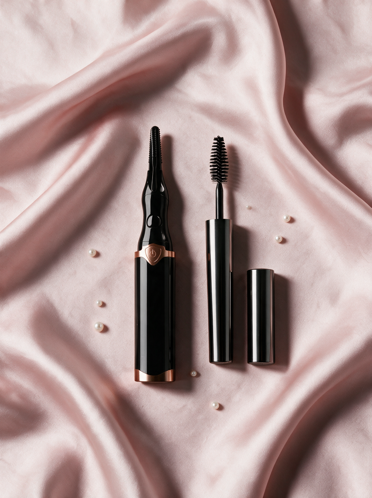 Lily Lash heated eyelash curler in black with Magic Mascara on blush silk